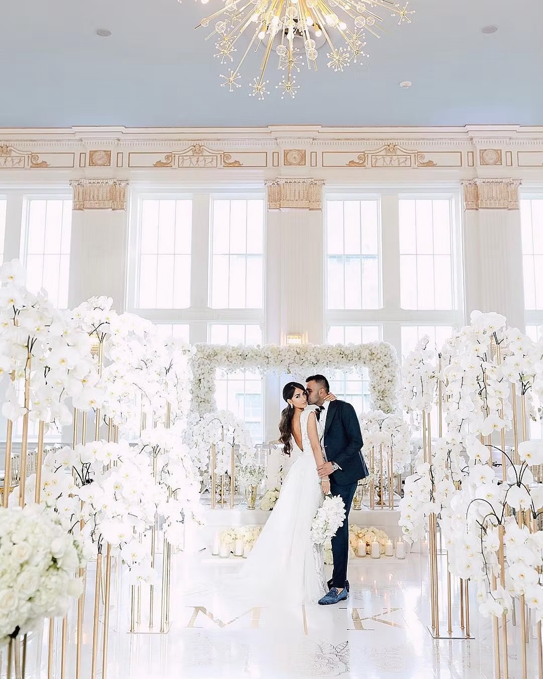 An orchid filled white ceremony inside the Crystal Ballroom