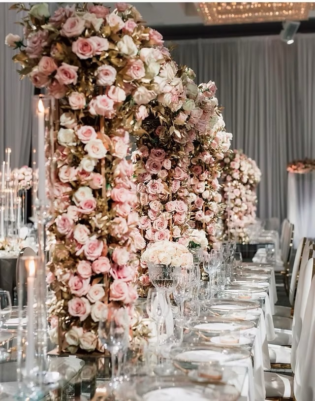 A romantic reception filled with arching blush rose installations