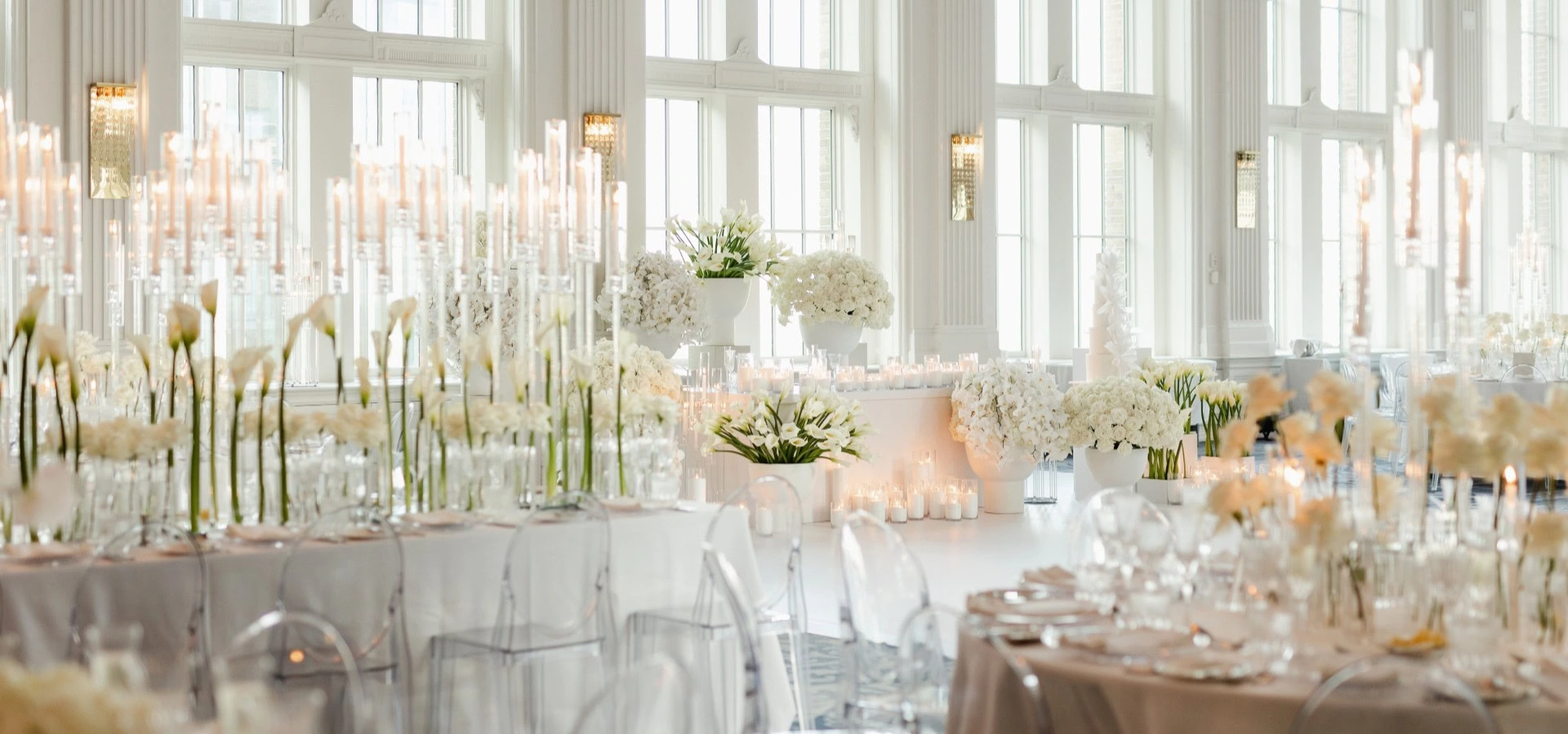 A candlelit reception filled with sculptural white flowers at the Omni King Edward Hotel