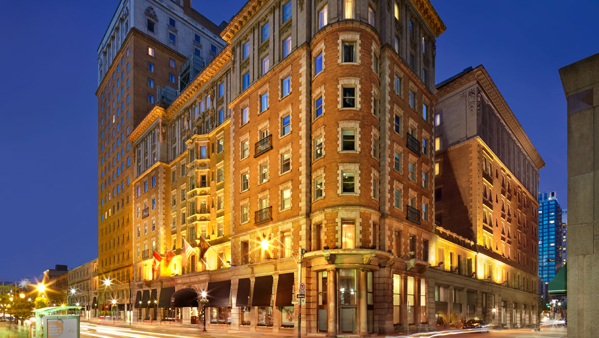The Omni King Edward Hotel’s illuminated historic exterior at dusk on King Street East in Toronto
