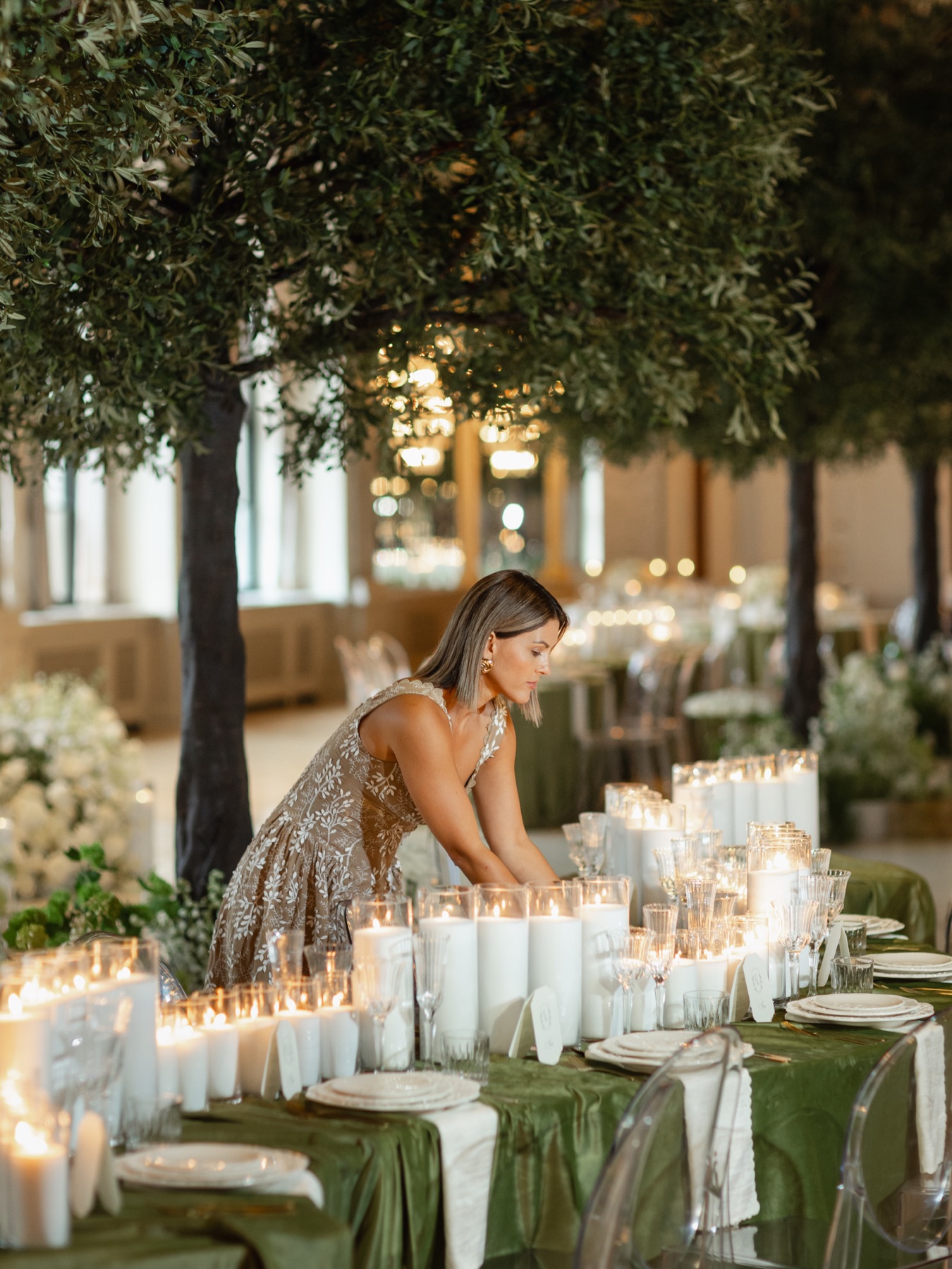 Sunny Kiani, founder of Lux Events Co, styling a candlelit wedding table