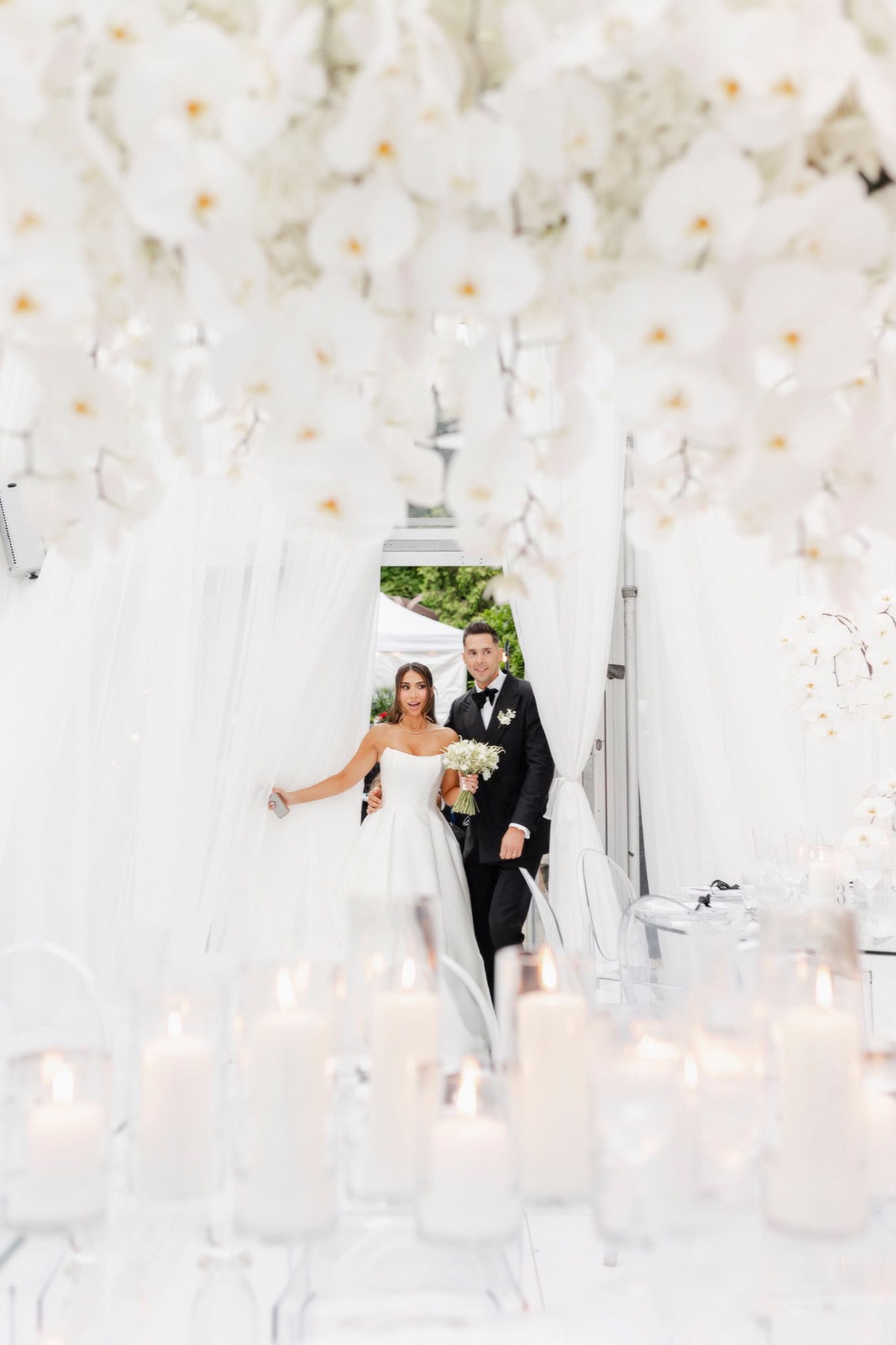A couple entering a bright white reception together
