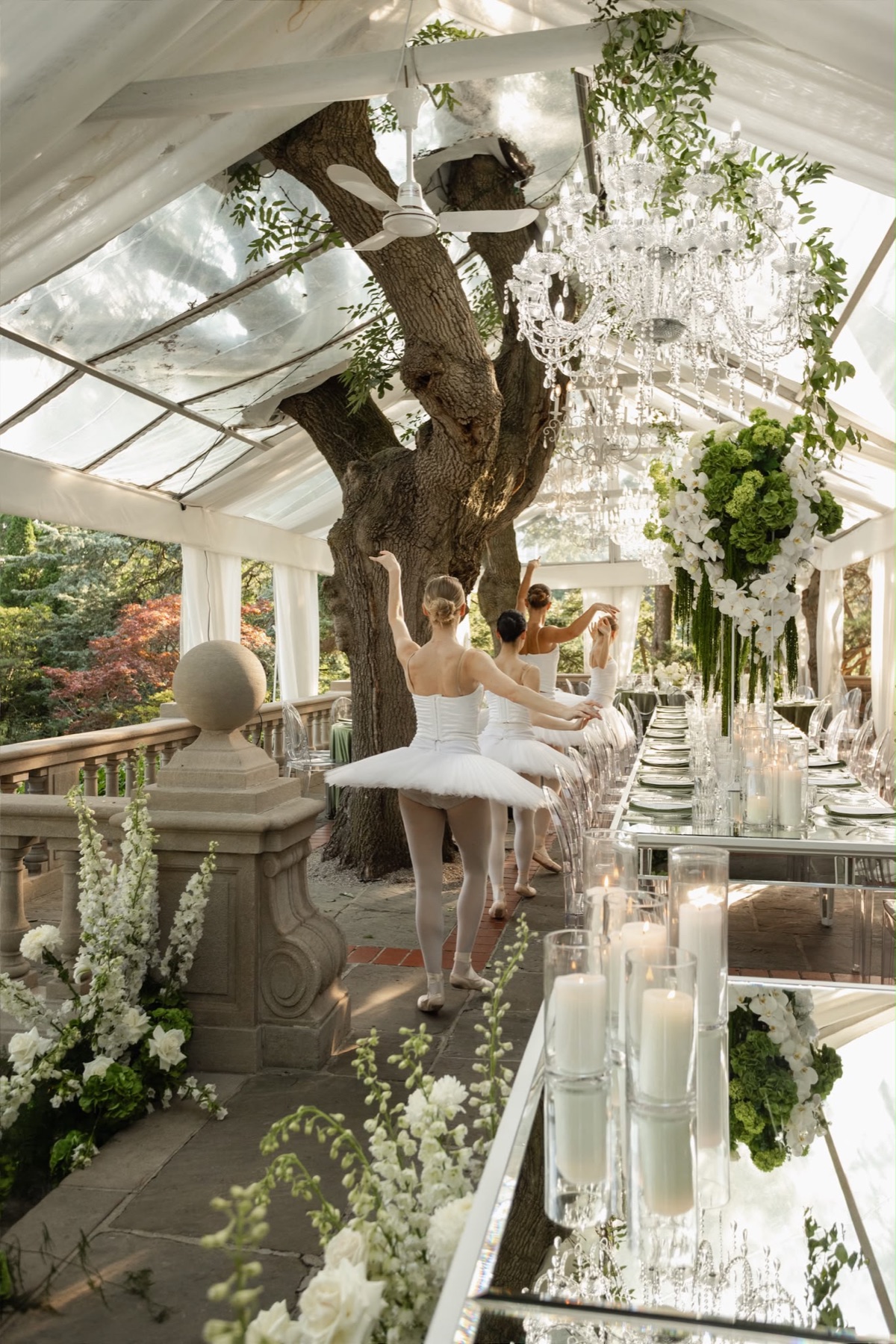 Ballet dancers moving through a garden reception