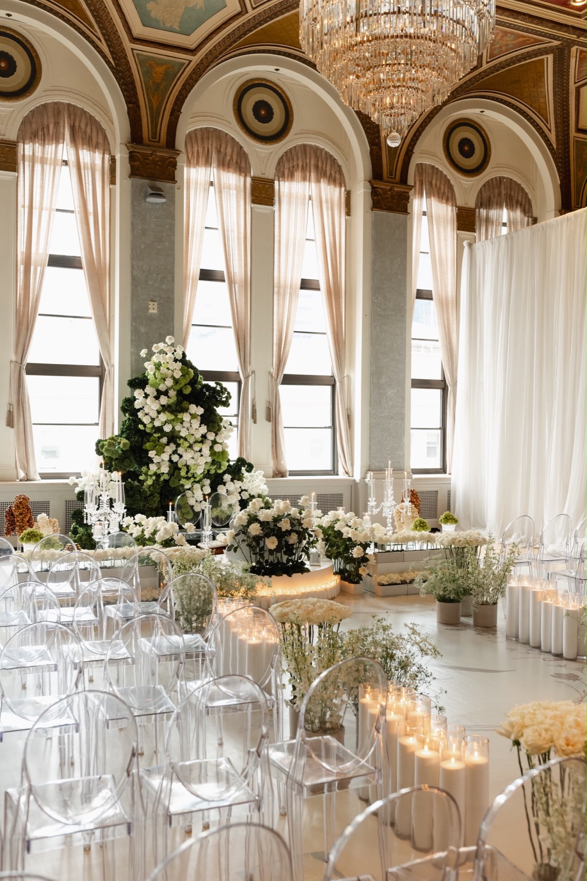 A white and green ceremony setting beneath the Fairmont ballroom ceiling